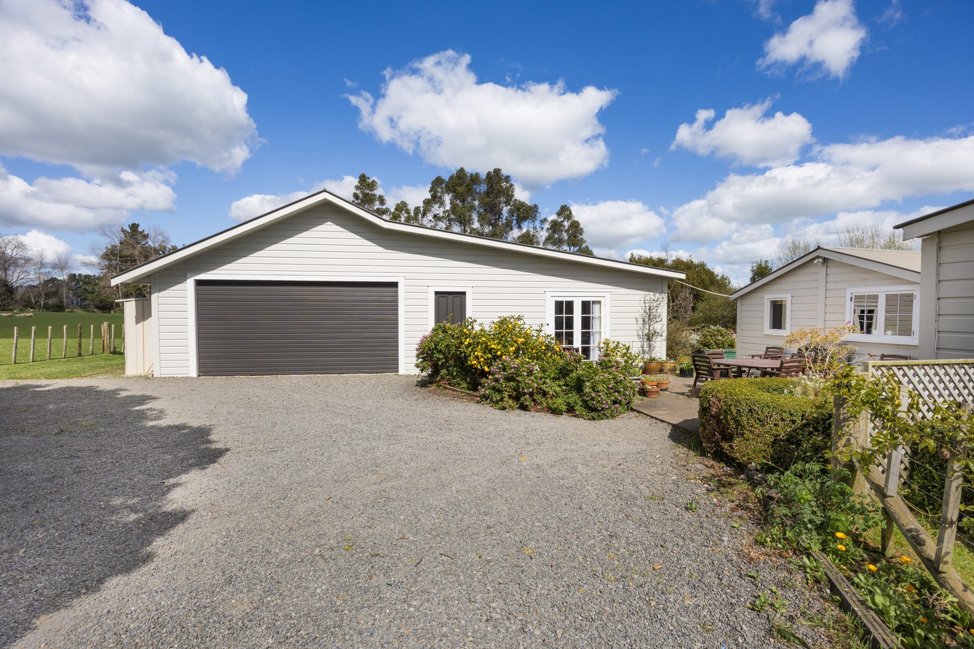 Double garage and sheds with a gravel forecourt at 2114 Kimbolton Road