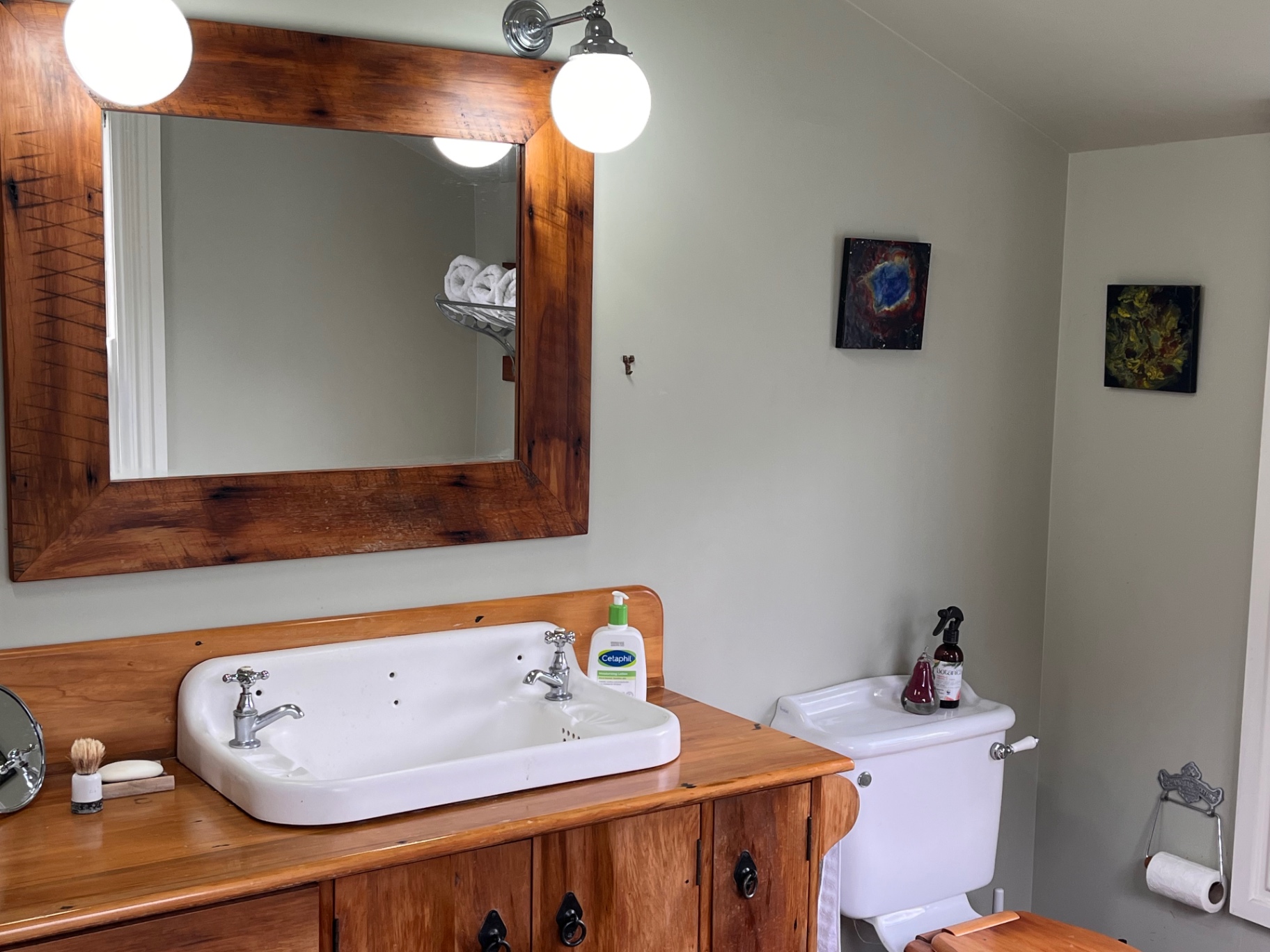 Bathroom vanity with a wooden-framed mirror